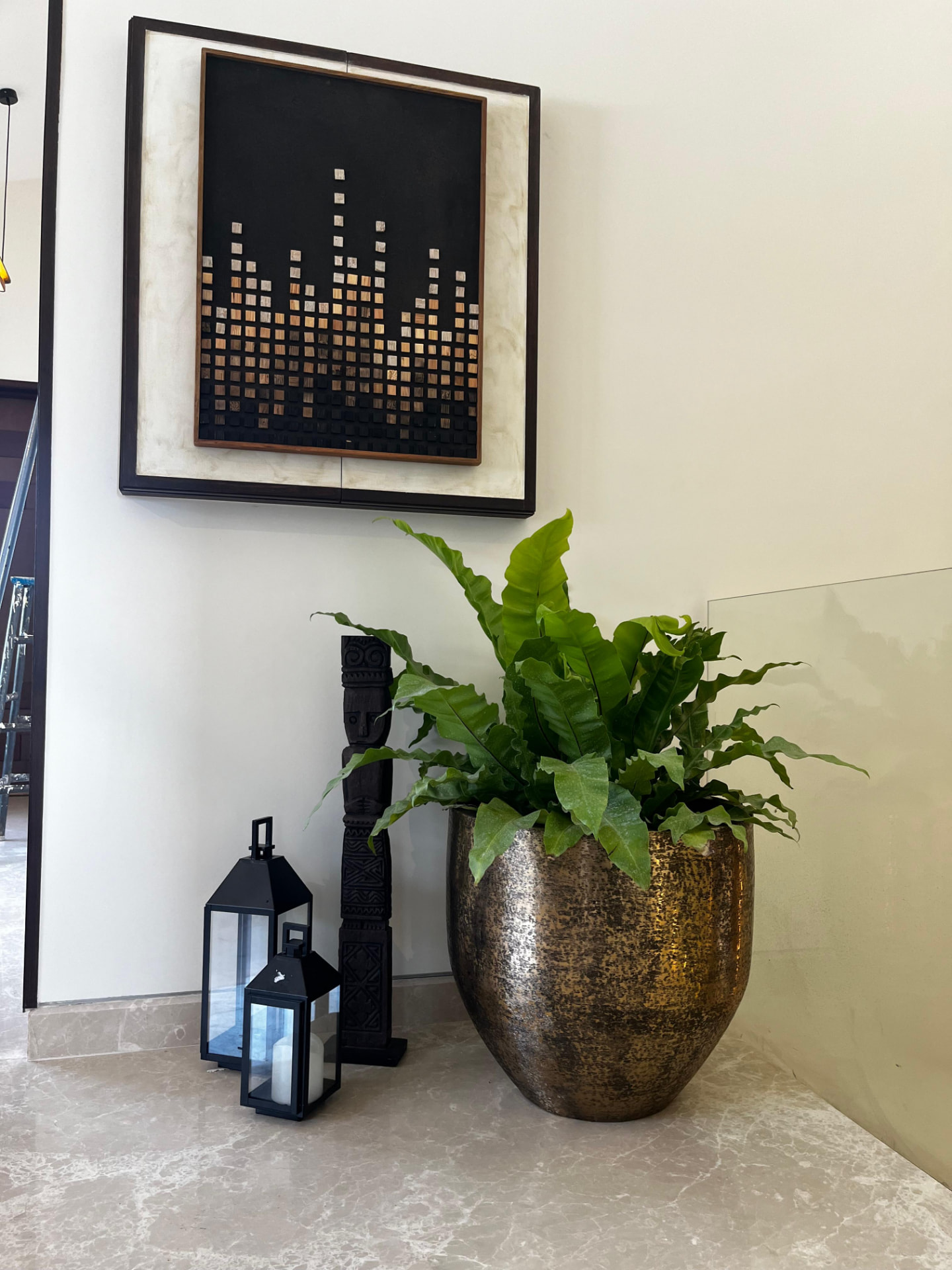 Bronze bowl and fern at the stair