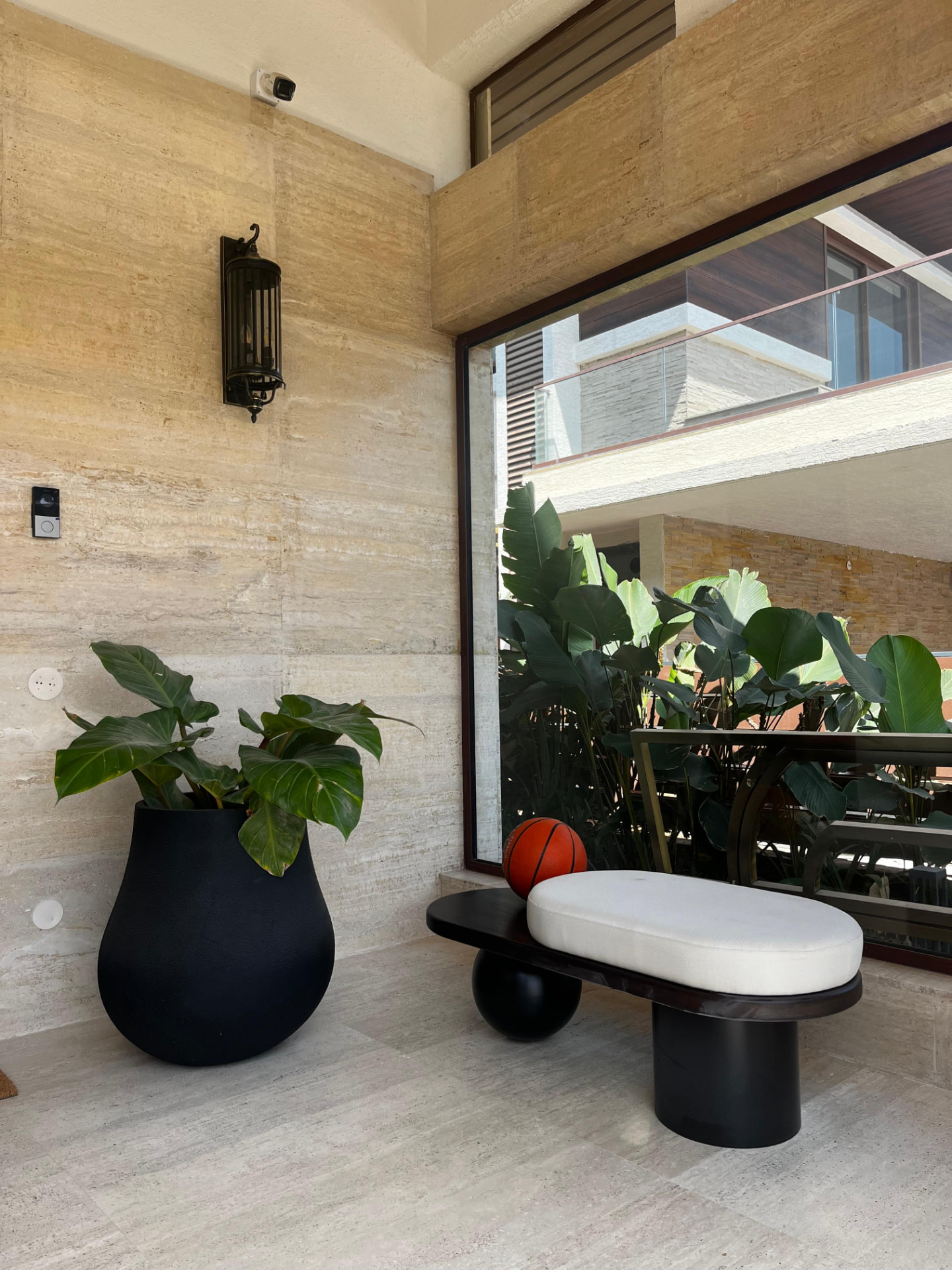 Matte black urn on travertine