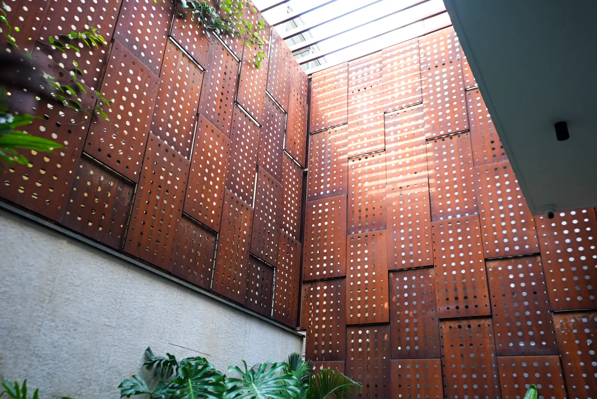 Perforated corten wall under the skylight